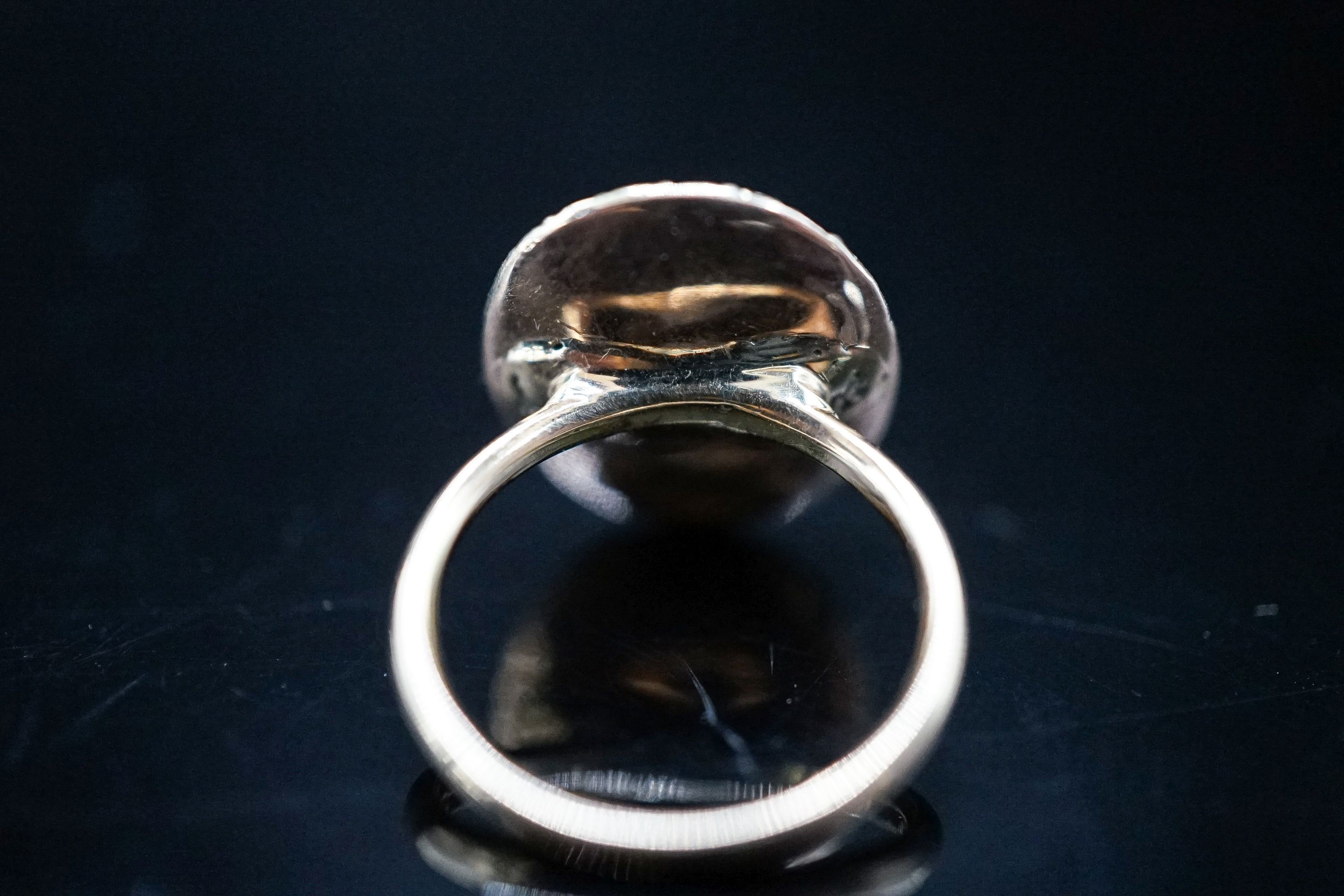 A 19th century yellow metal and gem set mounted glazed mourning ring, with 'S.H.' initialled above plaited hair, size I, gross weight 2.9 grams (adapted).